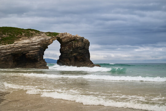 The sea and rocks at Praia das Catedrais, Beach of the Cathedrals in Ribadeo, Galicia Spain cloudy sky