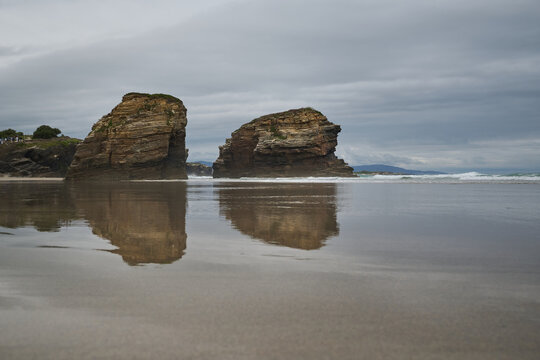 The sea and rocks at Praia das Catedrais, Beach of the Cathedrals in Ribadeo, Galicia Spain cloudy sky