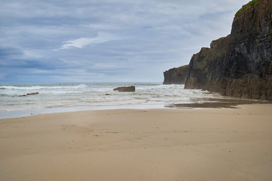 The sea and rocks at Praia das Catedrais, Beach of the Cathedrals in Ribadeo, Galicia Spain cloudy sky
