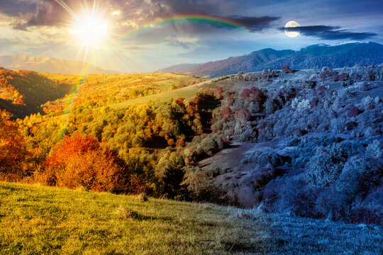 countryside landscape in autumn. day meet night. sun and moon over rural scenery in Carpathian mountains. colorful deciduous forest by the rural fields on a hillside under epic sky