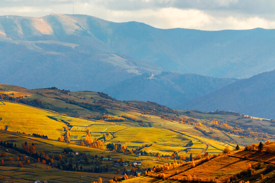 countryside mountain landscape of Ukraine in autumn. rural valley with rolling hills on a sunny day in fall colors. Mizhhirya district