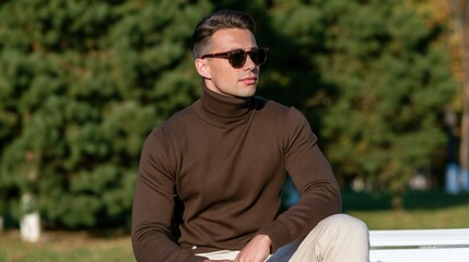 Obraz premium Man sits calmly on park bench