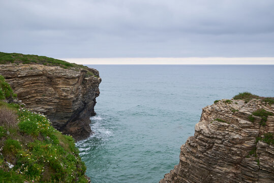 The sea and rocks at Praia das Catedrais, Beach of the Cathedrals in Ribadeo, Galicia Spain cloudy sky