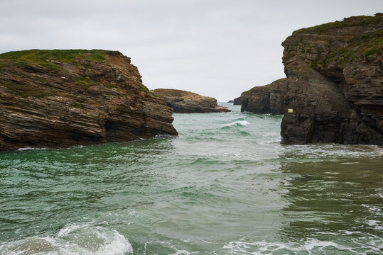The sea and rocks at Praia das Catedrais, Beach of the Cathedrals in Ribadeo, Galicia Spain cloudy sky