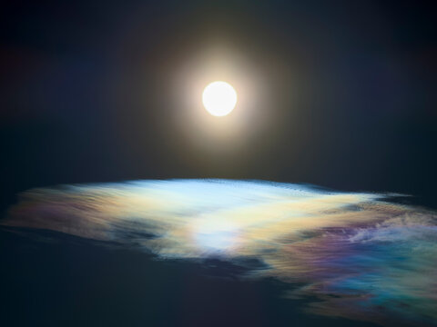 Sun above high clouds with rainbow colors in the ice crystals