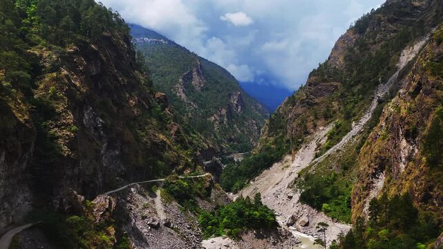 Rasuwagadhi, Rasuwa, Nepal - 29 August 2026: Aerial view of Trishuli river flowing through a deep mountain valley with steep rocky slopes, dense forest, and a winding road.