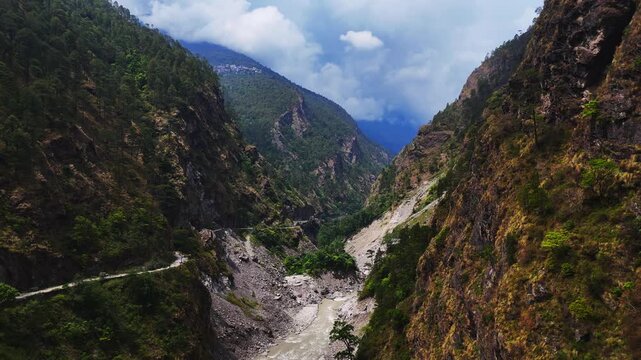 Rasuwagadhi, Rasuwa, Nepal - 29 August 2026: Aerial view of the Trishuli River flowing through a deep mountain valley with steep rocky slopes and a winding road.