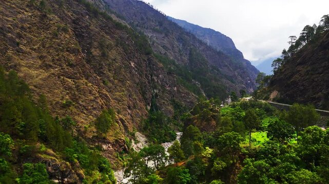 Rasuwagadhi, Nepal - 29 August 2026: Aerial view of the Trishuli River flowing through a deep valley surrounded by steep rocky mountains and lush green forests.