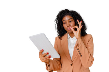 Black woman making an ok gesture and holding a tablet, showing approval and professionalism on transparent background © Komora