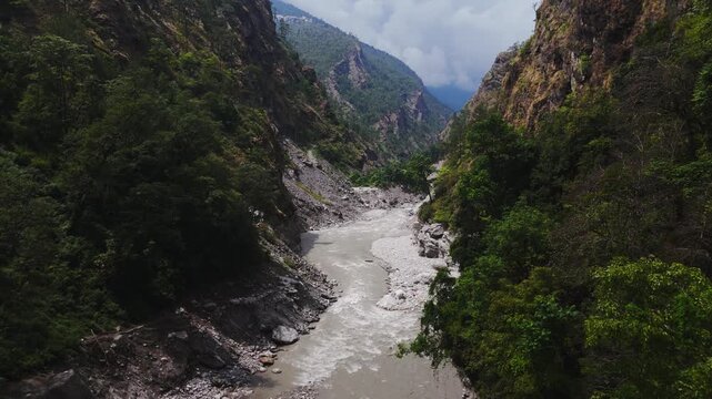 Langtang national park, Rasuwa, Nepal - 29 August 2026: Aerial view of the Trishuli river flowing through a deep, forested mountain valley with steep rocky slopes.