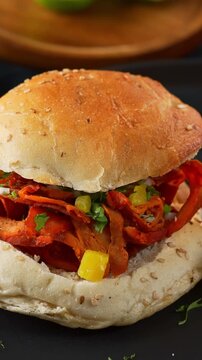 Close-up of a Mexican cemita sandwich filled with al pastor meat