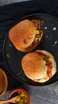 Delicious al pastor pork sandwich with pineapple chunks and herbs on sesame bread