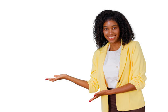 Happy african american woman in yellow blazer smiling, presenting, and gesturing a display, offering a clear space for content