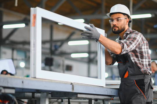 Worker assembling pvc window frame in factory