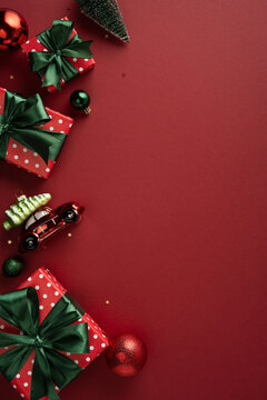 Christmas presents and ornaments on vertical red background with green bows and festive decorations for Merry Christmas and Happy New Year