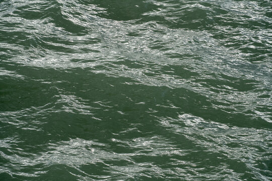 Waves moving in the water during daylight hours near the shore