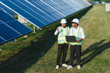 Indian engineers monitoring solar panels on an energy farm © Serhii