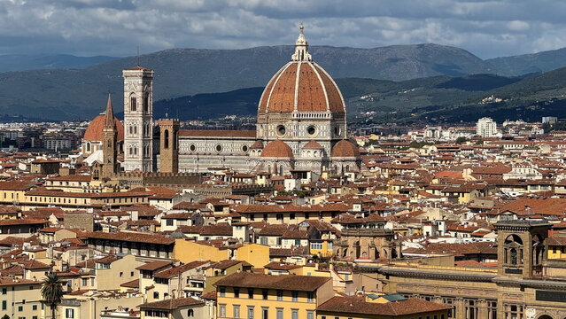 Panoramic view of Florence cathedral dome over historical rooftop skyline in Florence Italy for travel editorial