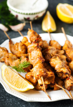 Close-up of a plate of Marinated Chicken skewers with lemon and yogurt dressing