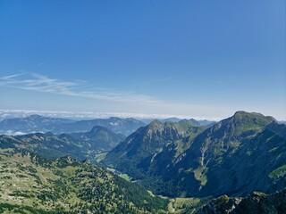 Fototapeta premium Breitachklamm Gorge in Bavaria, Germany, mountain river flowing in the middle of the cliffs, through the green forest. rapid flowing, raging, rushing. Sun rays and cool rock. Light and dark..