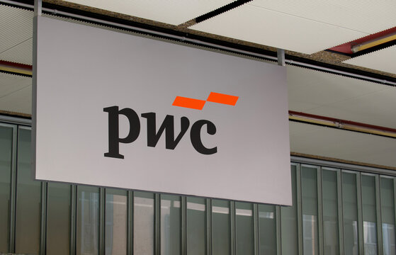 PwC logo hanging sign outside office building in Lugano Switzerland