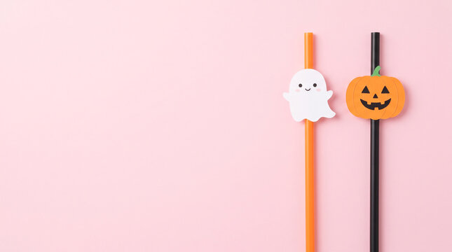 Halloween party drinking straws with cute ghost and pumpkin decorations on pink background