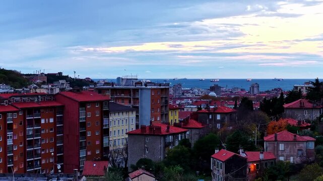 Aerial view of the historic city of Trieste with red-tiled rooftops and the Adriatic Sea in the background in Trieste, Friuli-Venezia Giulia, Italy.