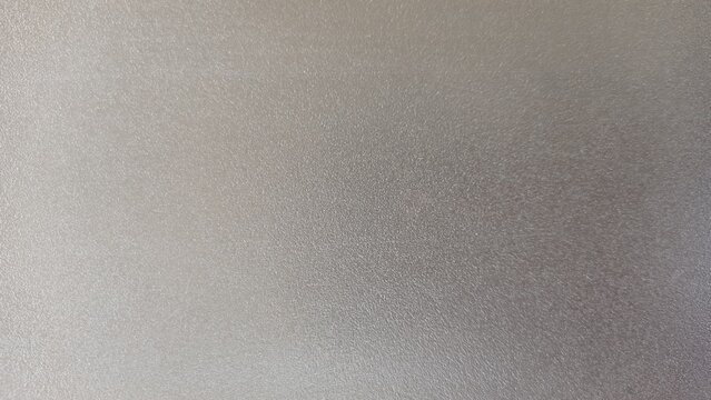 A grainy-textured background with a gray gradient and slight blur.