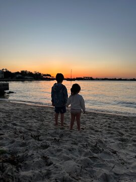 Kids watching the sunset on the beach