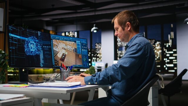 Male specialist uses artificial intelligence and neural networks to design an apartment floor plan, working with computer-aided layout tools and architectural software for interior design planning.