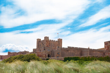 Ancient stone Bambourgh fortress view from dunes, Great Britain © Sergey Novikov
