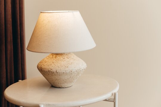 Modern Beige Table Lamp With Textured Base On Side Table