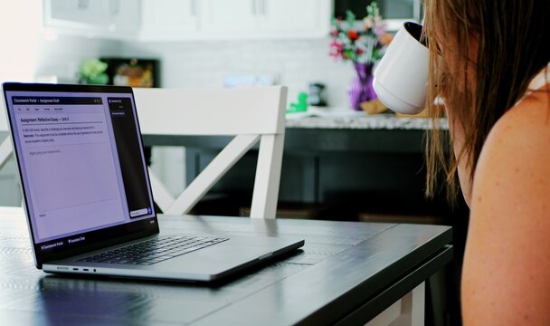 Adult college student uses artificial intelligence AI chat bot to write assignment breaking academic fair use policy cheating educational assignment