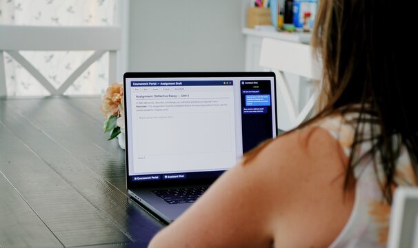 Adult college student uses artificial intelligence AI chat bot to write assignment breaking academic fair use policy cheating educational assignment