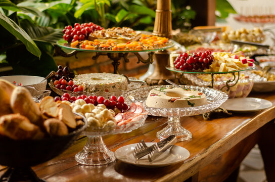 Elegant buffet table with assorted cheeses, fruits, cold cuts and appetizers