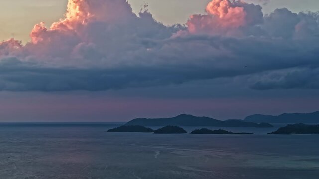 Aerial view of Port Barton Beach islands at sunset with dramatic clouds over the sea in Mimaropa, Philippines.