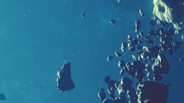 Asteroids are scattered in space with a bright blue background and distant stars twinkling. The scene shows rocky surfaces and various sizes of asteroids floating peacefully.