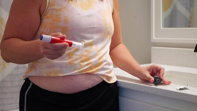 Middle aged female providing GLP1 shot in stomach for weight loss, obesity, diabetes, weight management - Expensive pharmacueticals game changing meds