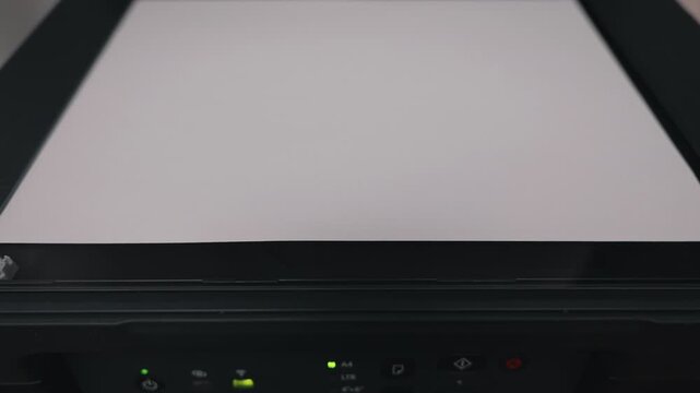 Office worker placing blank paper on multifunction scanner