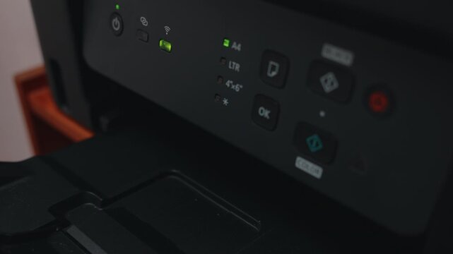Printed document coming out of multifunction office printer