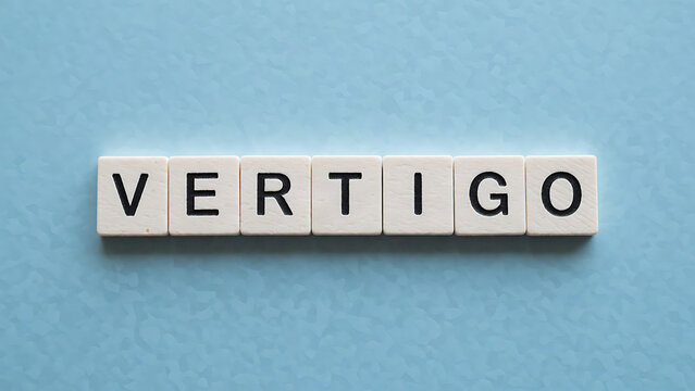 Minimalist wooden Scrabble-style blocks spelling Vertigo on blue background