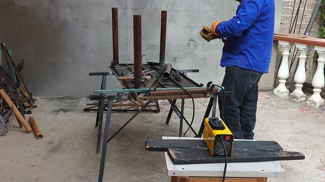 Young Welder Preparing Recycled Steel Pipes to Assemble Workshop Table