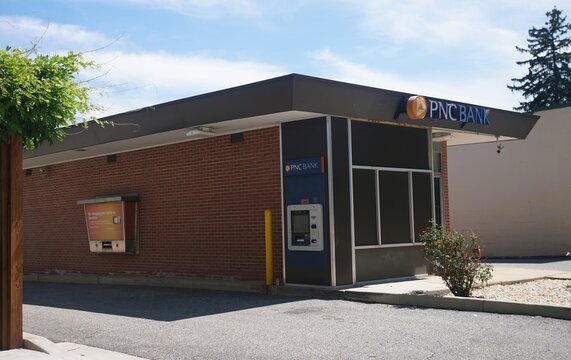 Havre de Grace, Maryland, U.S.A - Aug 29, 2026 - The exterior view of a brick PNC Bank building featuring a drive-through lane and an Automated Teller Machine.