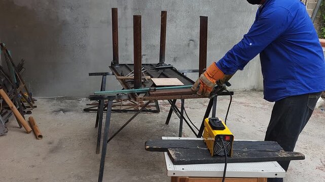 Removing Scrap Metal Pieces from Table Frame to Continue Welding