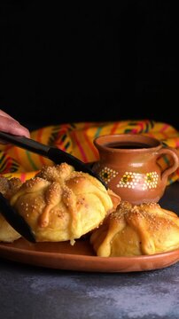 Mexican day of the dead sweet bread with traditional woven napkin background
