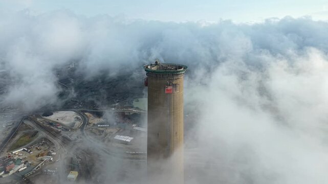 Smelter stack in morning clouds