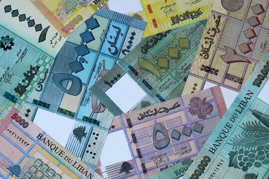 Lebanese pound money bills in pile on table. Lebanon LBP currency cash close up