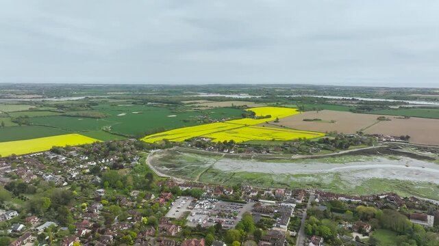 Fields and Farms over Bosham Quay from a drone at low tide, Chichester Harbour National Landscape, Chichester, West Sussex, England