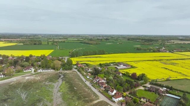 Fields and Farms over Bosham Quay from a drone at low tide, Chichester Harbour National Landscape, Chichester, West Sussex, England