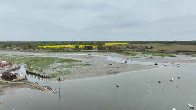 Fields and Farms over Bosham Quay from a drone at low tide, Chichester Harbour National Landscape, Chichester, West Sussex, England